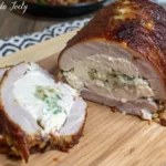 Juicy jalapeño stuffed pork tenderloin wrapped in crispy bacon and smoked to perfection on a wood grill