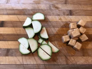 Collage showing three easy Tofu Day Recipes: a bowl of tofu soup, fresh tofu spring rolls, and tomato tofu with rice