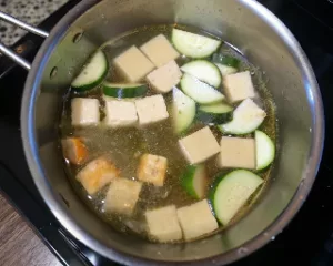 Savory tomato tofu simmered in sauce served over white rice - easy Tofu Day dinner recipe.