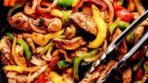 Plate of easy chicken fajitas with colorful bell peppers and onions